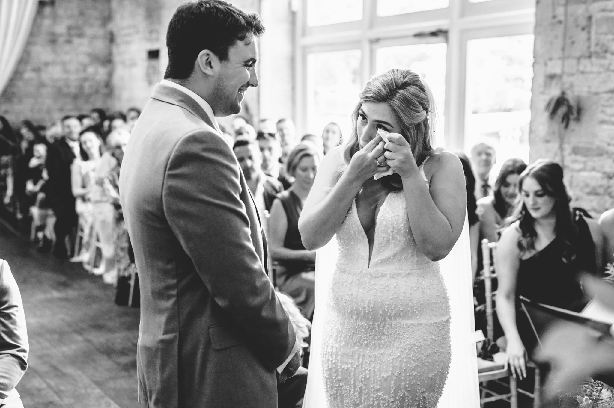 a bride wiping away a tear at Lapstone Barn wedding venue during her wedding ceremony
