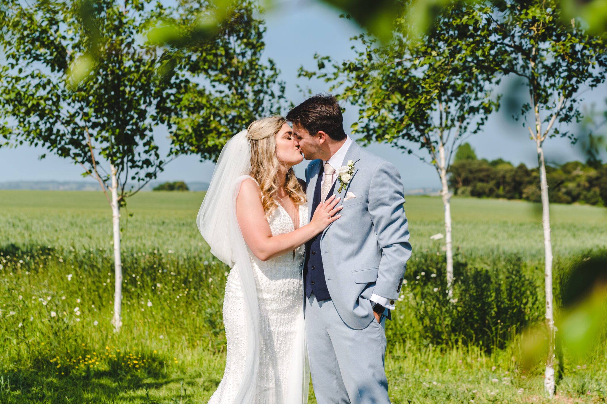 A couple sharing a kiss at lapstone barn in the gardens