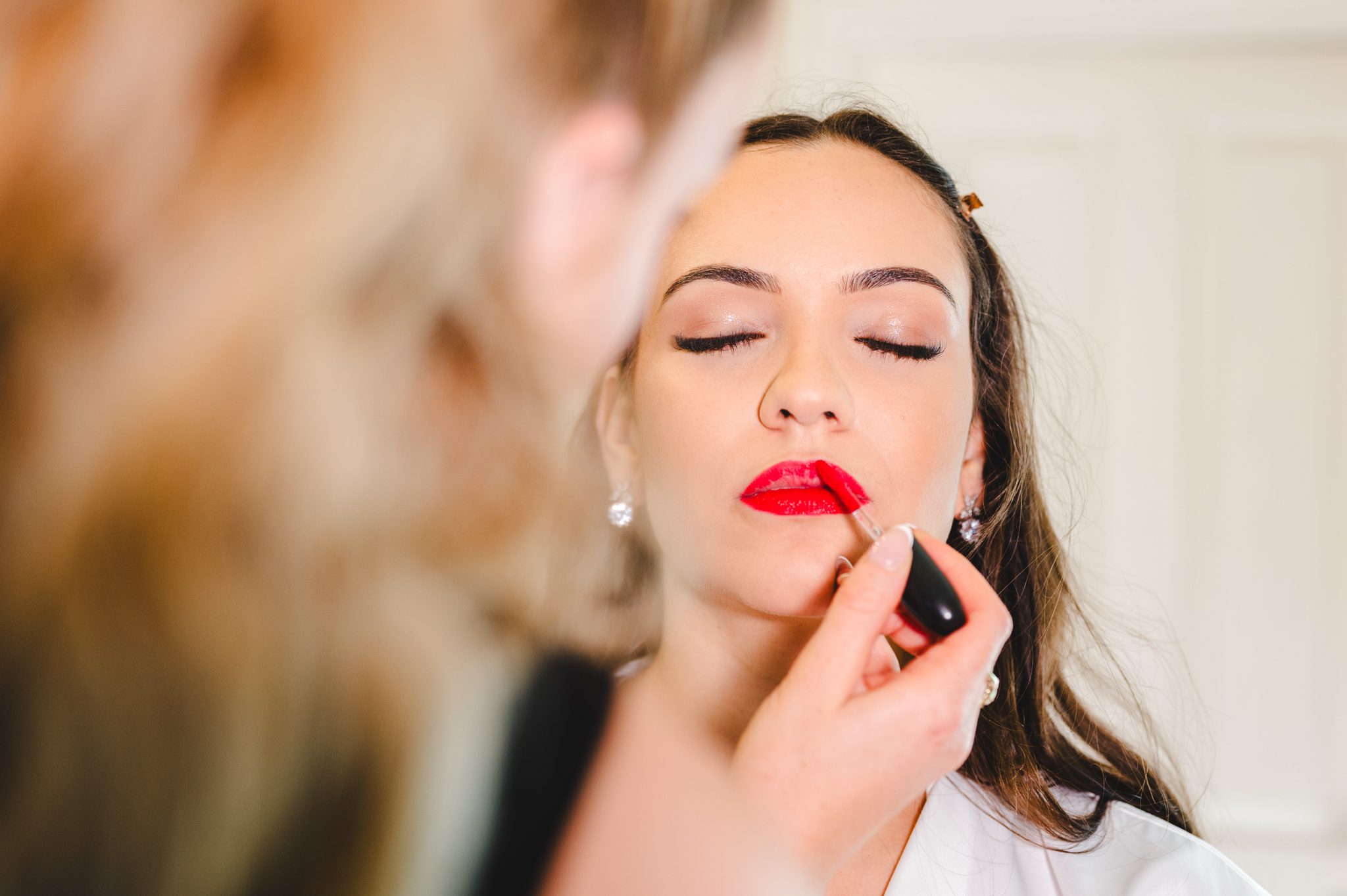 A bride having red lipstick added