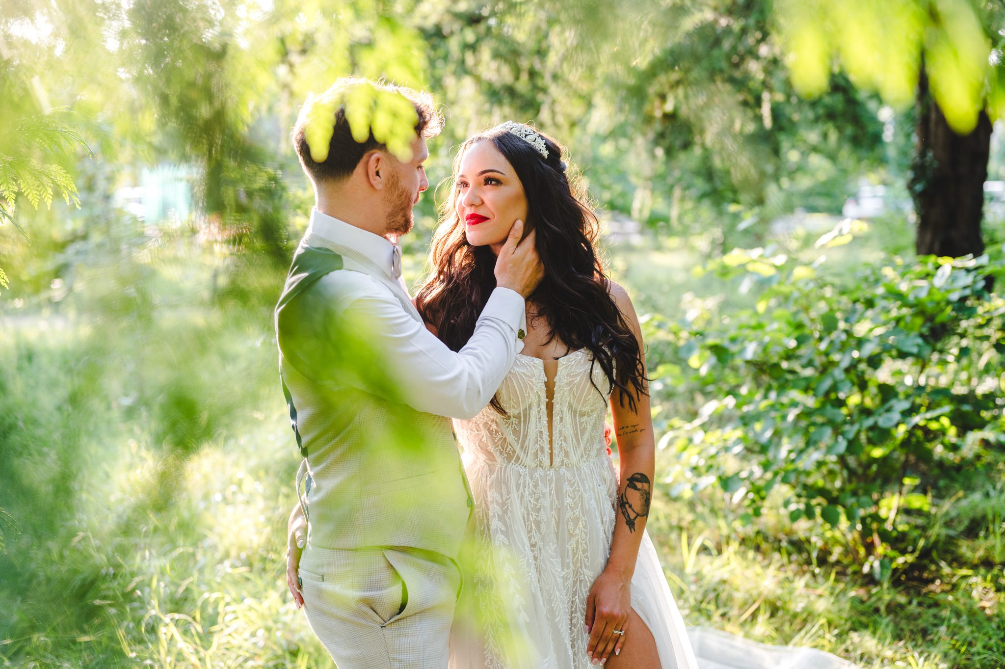 A bride and groom stood in woodland at manor by the lake