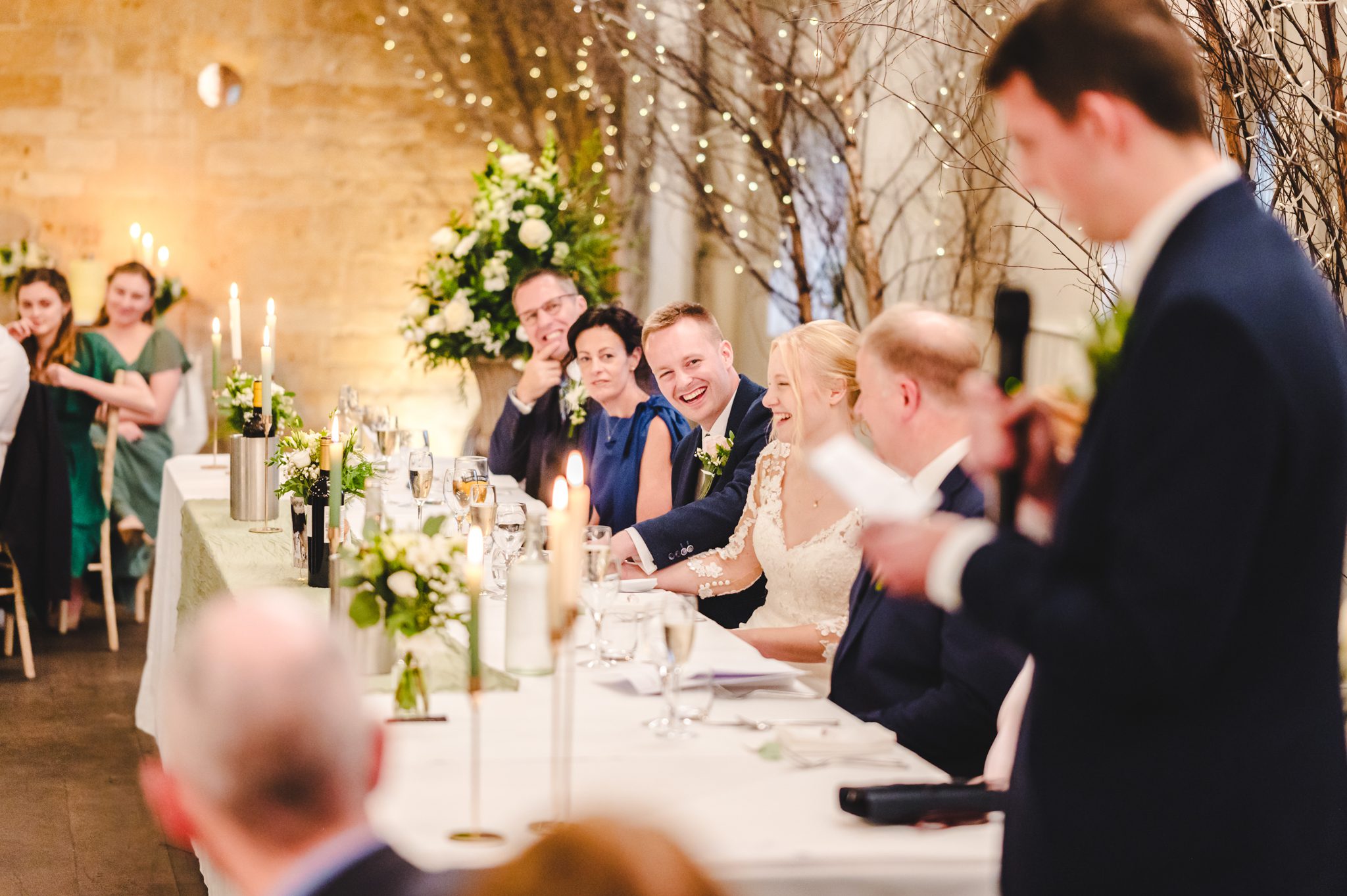 a group of people sitting at a long table