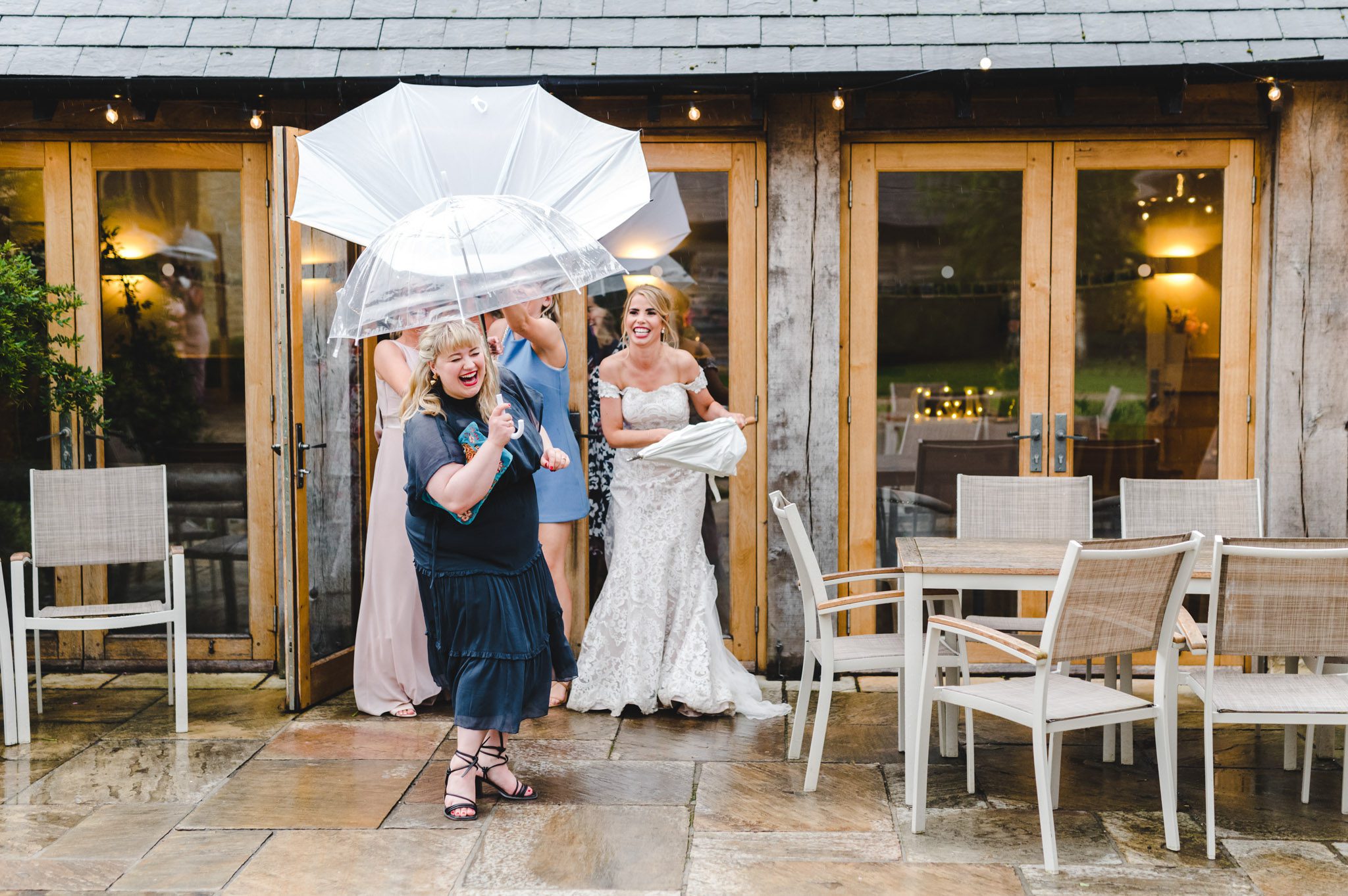 A wedding guest holding an umbrella at Upcote Barn wedding show