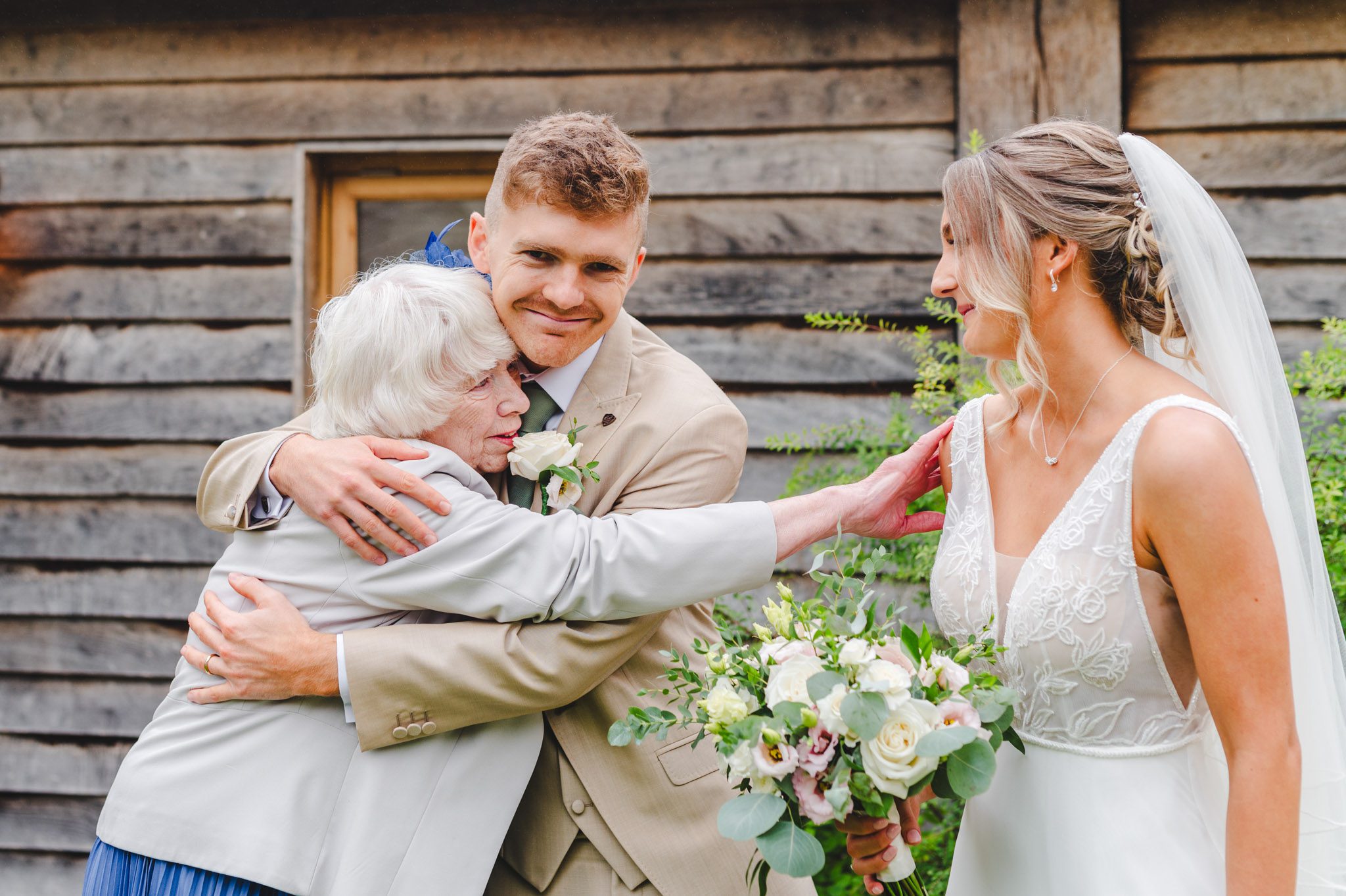 a groom hugging his grandma