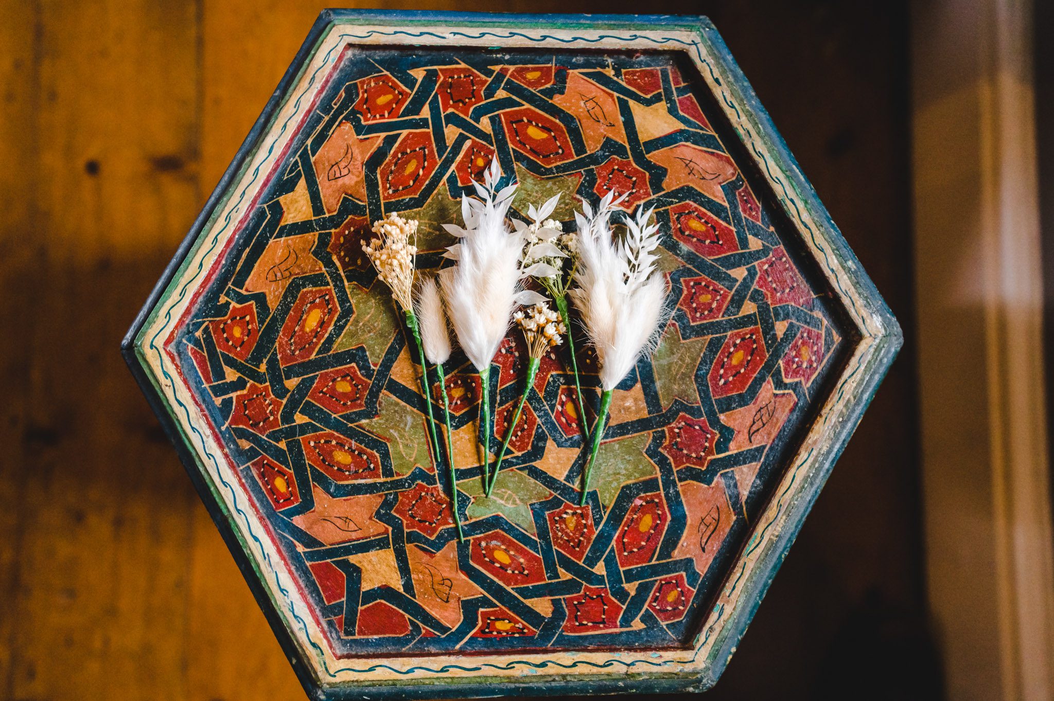 Some buttonhole flowers on a decorative table
